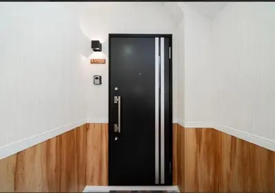 a black door in a room with wooden floors at Oshiage SAIEI Hotel 401 in Tokyo