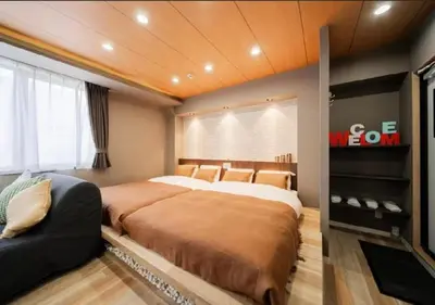 a bedroom with a large bed and a television at Oshiage SAIEI Hotel 401 in Tokyo
