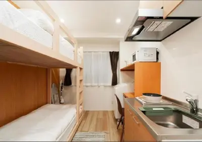 a small kitchen with a bunk bed and a sink at Oshiage SAIEI Hotel 403 in Tokyo