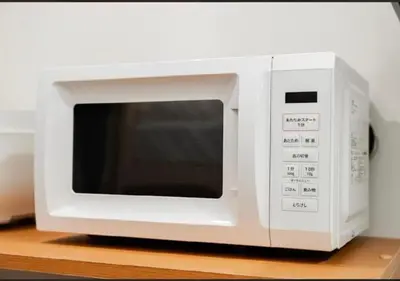 a white microwave oven sitting on top of a counter at Oshiage SAIEI Hotel 403 in Tokyo