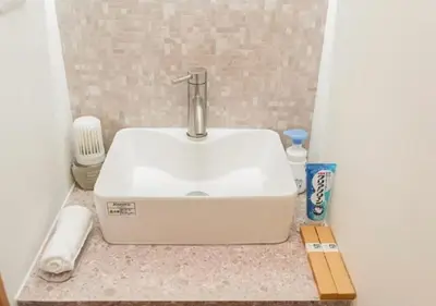 a white sink on a counter in a bathroom at Oshiage SAIEI Hotel 403 in Tokyo