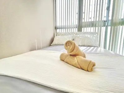 a teddy bear sitting on top of a bed at Shinjuku City Apt, 2DB , Free WiFi in Tokyo