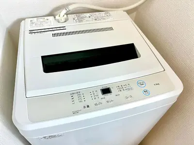 a white washing machine sitting on top of a wall at Shinjuku City Apt, 2DB , Free WiFi in Tokyo