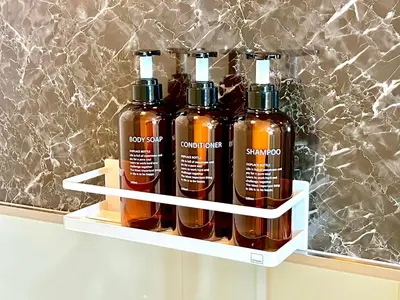 a shelf with four bottles of honey on it at Shinjuku City Apt, 2DB , Free WiFi in Tokyo