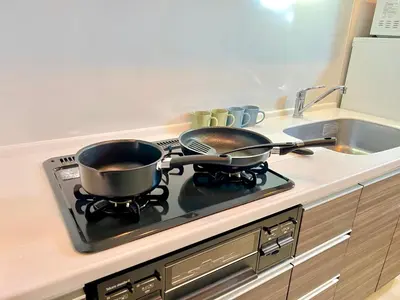 two pots and pans sitting on a stove in a kitchen at Shinjuku City Apt, 2DB , Free WiFi in Tokyo
