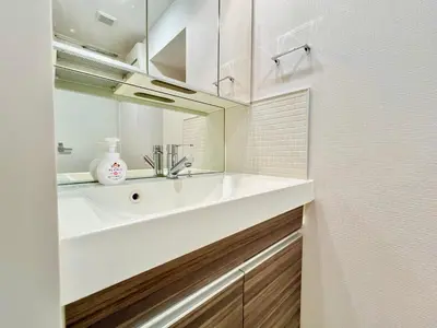a bathroom with a white sink and a mirror at Shinjuku City Apt, 2DB , Free WiFi in Tokyo