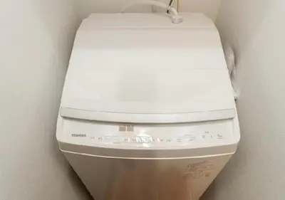 a white toilet sitting in a corner in a bathroom at Oshiage SAIEI Hotel 402 in Tokyo
