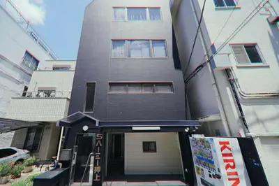 a tall building with a garage in front of it at Oshiage SAIEI Hotel 402 in Tokyo