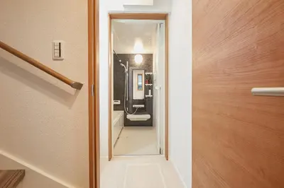 a hallway with a door leading into a room at Miraisya Hatsudai in Tokyo