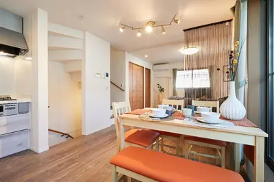 a kitchen and dining room with a table and chairs at Miraisya Hatsudai in Tokyo