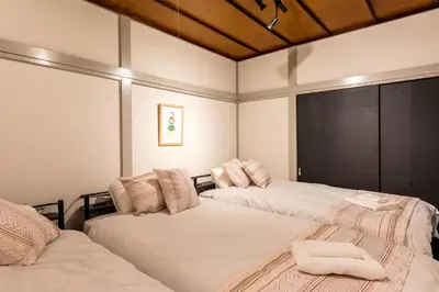 a bedroom with two beds with towels on them at AkebonoHouse201 in Tokyo
