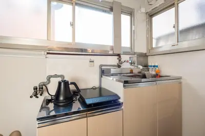 a small kitchen with a stove and a sink at AkebonoHouse201 in Tokyo