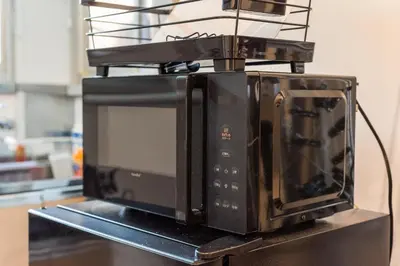 a microwave oven sitting on top of a counter at AkebonoHouse201 in Tokyo