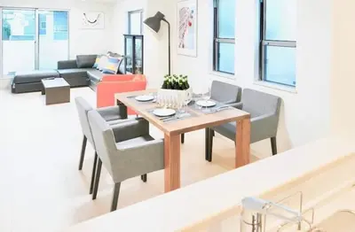 a living room with a table and chairs and a couch at miraisya shiinamachi in Tokyo