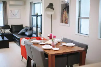 a dining room table and chairs in a living room at miraisya shiinamachi in Tokyo