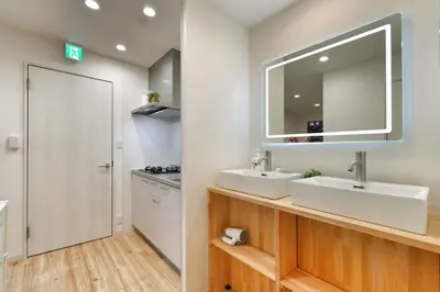 a bathroom with two sinks and a mirror at miraisya kyojima in Tokyo