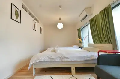 a bedroom with a bed and a window at miraisya kyojima in Tokyo