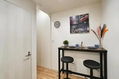 a hallway with a table and two stools in a room at miraisya kyojima in Tokyo