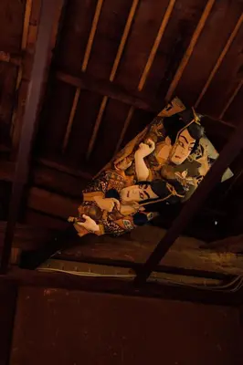 a woman laying on a bed in a attic at Ivy Harajuku in Tokyo