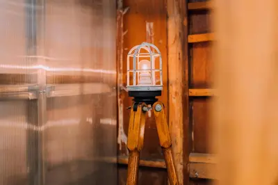a bird cage on a tripod in a room at Ivy Harajuku in Tokyo