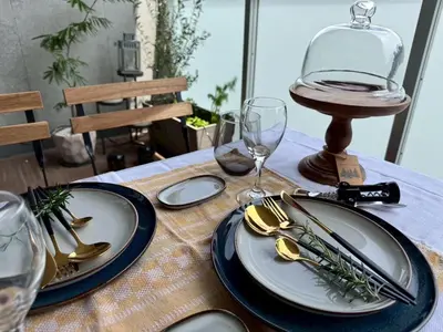 a table with plates and silverware on a table at Monthly \u516d\u672c\u6728\u9ebb\u5e03\u30b9\u30ab\u30a4\u30c6\u30e9\u30b9 in Tokyo