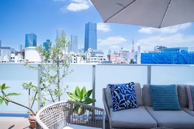 a couch on a balcony with a view of the city at \u516d\u672c\u6728\u9ebb\u5e03\u30b9\u30ab\u30a4\u30c6\u30e9\u30b9 in Tokyo
