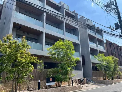 an apartment building with trees in front of it at \u516d\u672c\u6728\u9ebb\u5e03\u30b9\u30ab\u30a4\u30c6\u30e9\u30b9 in Tokyo