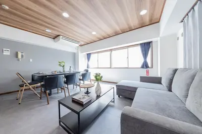 a living room with a couch and a table at Hanna Inn Shinbashi Onarimon in Tokyo