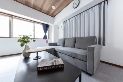 a living room with a couch and a table at Hanna Inn Shinbashi Onarimon in Tokyo