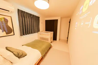 a small bedroom with a bed and a window at Seven's Inn Tateishi in Tokyo