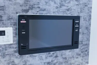 a black microwave oven sitting on top of a wall at Seven's Inn Tateishi in Tokyo