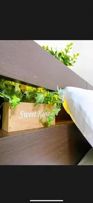 a wooden planter with plants on a wooden bench at The Aki Shinjuku in Wada