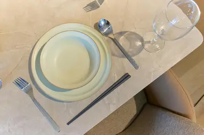 a table with a plate and cutlery on it at U Place Shimokitazawa by Tranova in Tokyo