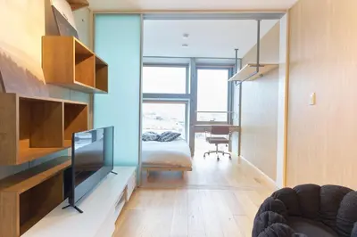 a room with a tv and a bed and a desk at U Place Shimokitazawa by Tranova in Tokyo