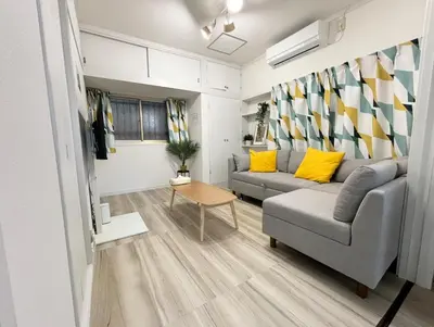 a living room with a couch and a table at sgc\u6771\u7acb\u77f32\u4e01\u76ee in Tokyo