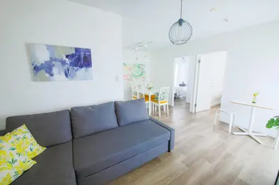 a living room with a couch and a dining room at 4 min to Shinjuku - Up to 8pax - 3BR - Near Shibuya, Harajuku in Tokyo