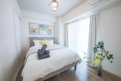 a bedroom with a bed with a stuffed animal on it at 4 min to Shinjuku - Up to 8pax - 3BR - Near Shibuya, Harajuku in Tokyo