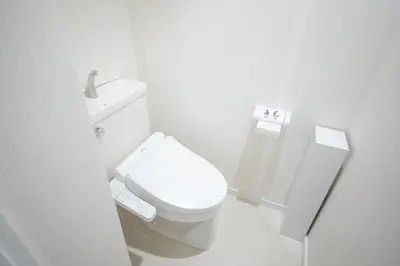 a white bathroom with a toilet and a sink at 4 min to Shinjuku - Up to 8pax - 3BR - Near Shibuya, Harajuku in Tokyo