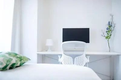 a white bedroom with a desk and a chair at 4 min to Shinjuku - Up to 8pax - 3BR - Near Shibuya, Harajuku in Tokyo