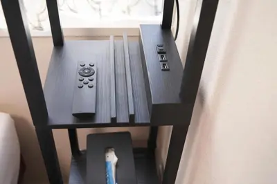 a table with two remote controls on it next to a window at SGC\u8535\u524d2\u4e01\u76ee3f in Tokyo
