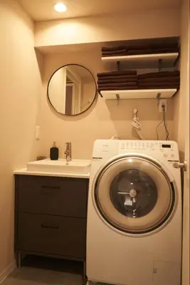 a bathroom with a washing machine and a sink at SGC\u8535\u524d2\u4e01\u76ee3f in Tokyo