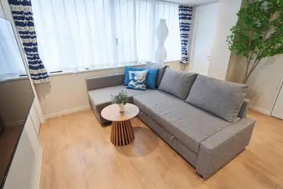a living room with a couch and a table at SGC\u8535\u524d2\u4e01\u76ee3f in Tokyo