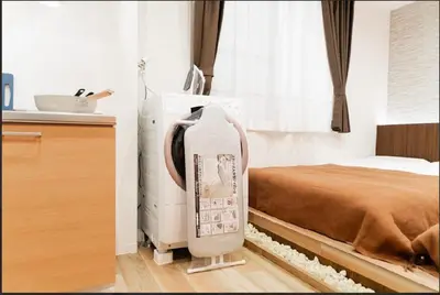 a room with a bed and a large water heater at SAIE Sakura hotel in Tokyo