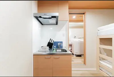 a kitchen with a sink and a microwave at SAIE Sakura hotel in Tokyo