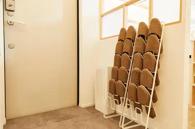 a rack of shoes in a room next to a door at Tokyo Sky Suite Hotel in Tokyo