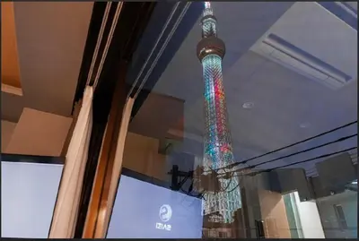 a reflection of the eiffel tower in a window at SAIE Skyview hotel in Tokyo