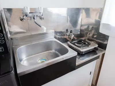 a kitchen with a sink and a stove at Better Than Outside 12 min Shibuya by train in Tokyo