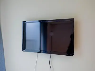 a flat screen tv hanging on a wall at Better Than Outside 12 min Shibuya by train in Tokyo