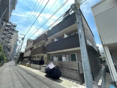 a building with a trash bag on the street at Yoi-Machi Heiwajima in Tokyo
