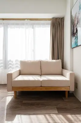 a living room with a couch in front of a window at Second Home SHINJUKU in Tokyo